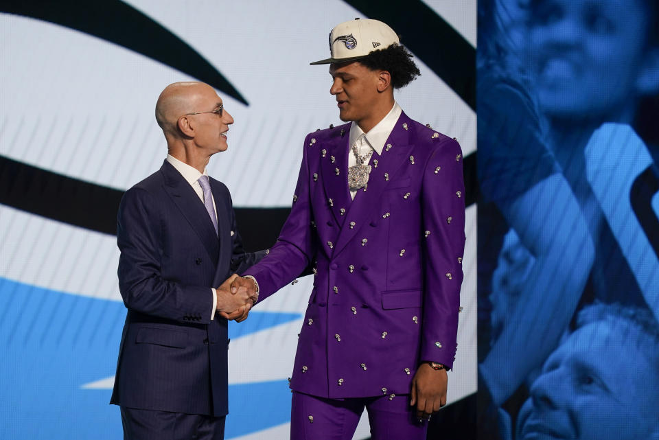 Paolo Banchero, right, is congratulated by NBA Commissioner Adam Silver after being selected as the number one pick overall by the Orlando Magic in the NBA basketball draft, Thursday, June 23, 2022, in New York. (AP Photo/John Minchillo)