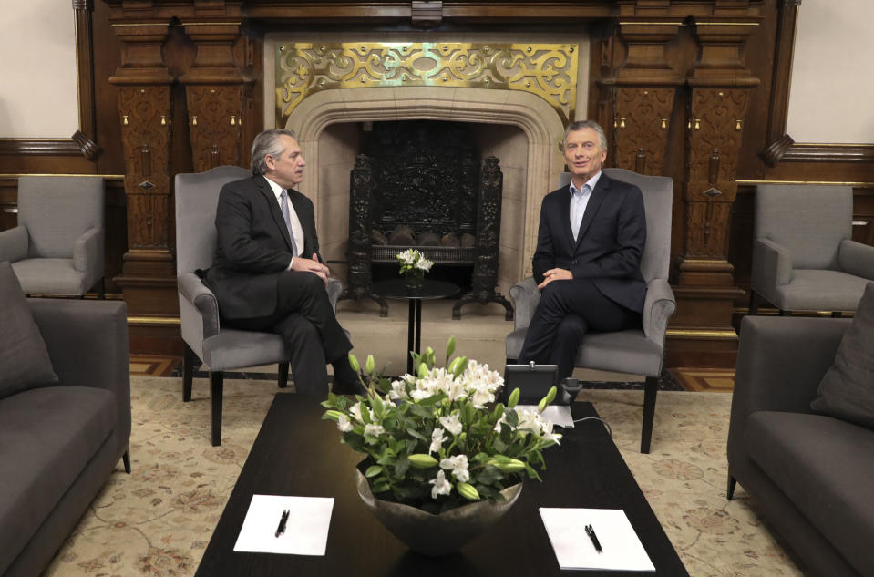 In this handout photo provided by Argentina's presidential press office, presidential candidate Alberto Fernandez, left, meets with Argentina's President Mauricio Macri at Government House in Buenos Aires, Argentina, Monday, Oct. 28, 2019. Argentina's Peronists are celebrating their return to power after incumbent Macri conceded defeat in a dramatic election that likely swung the country back to the center-left and threatened to rattle financial markets (Presidencia de la Nacion via AP)