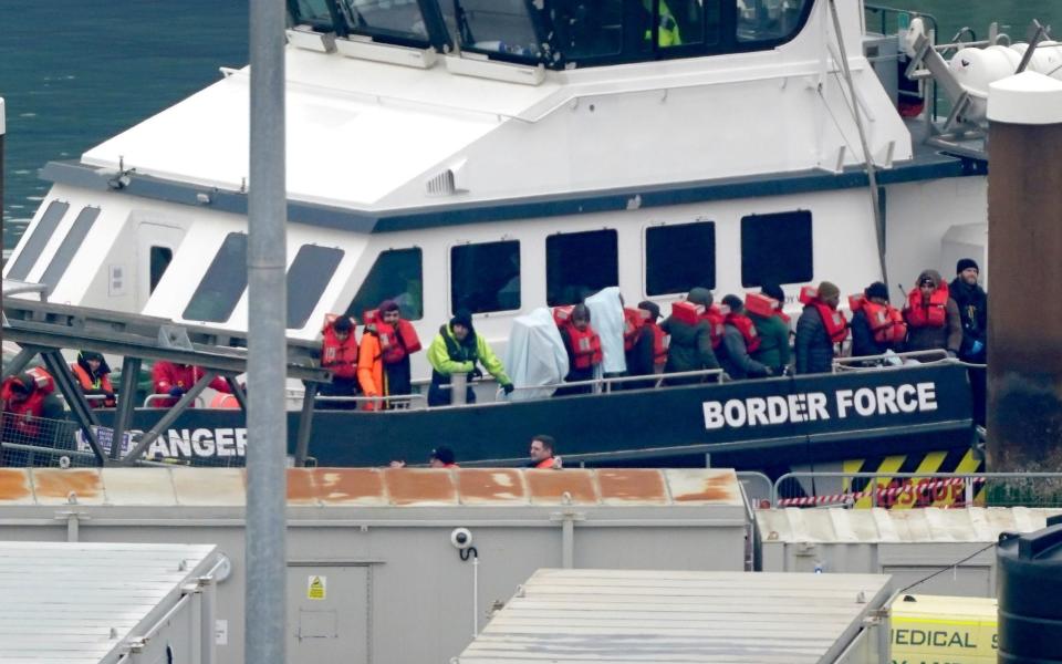 A group of people thought to be migrants are brought in to Dover, Kent, onboard a Border Force vessel following a small boat incident in the Channel on Jan 25 - PA