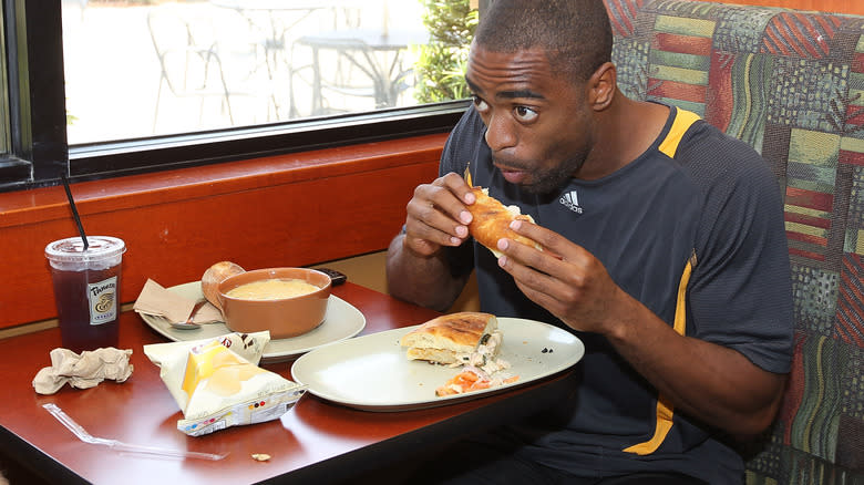 man eating at panera bread