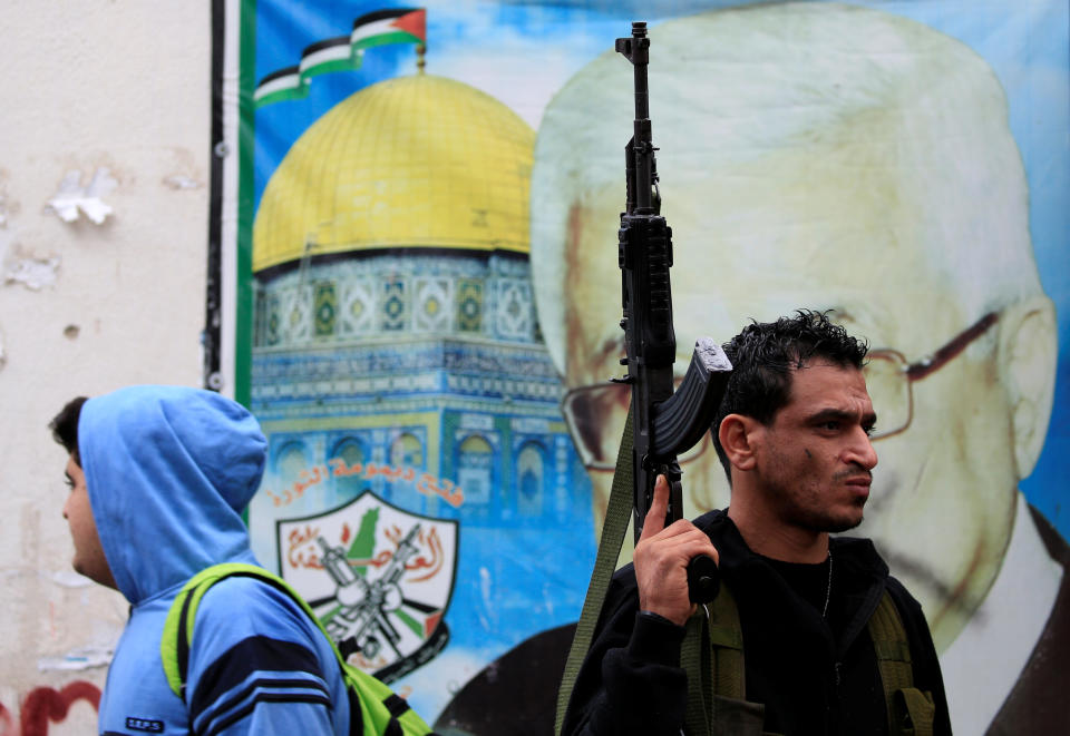 <p>A member of the Palestinian Fatah faction holds a gun inside the Ain el-Hilweh refugee camp near Sidon, southern Lebanon, December 6, 2017. (Photo: Ali Hashisho/Reuters) </p>