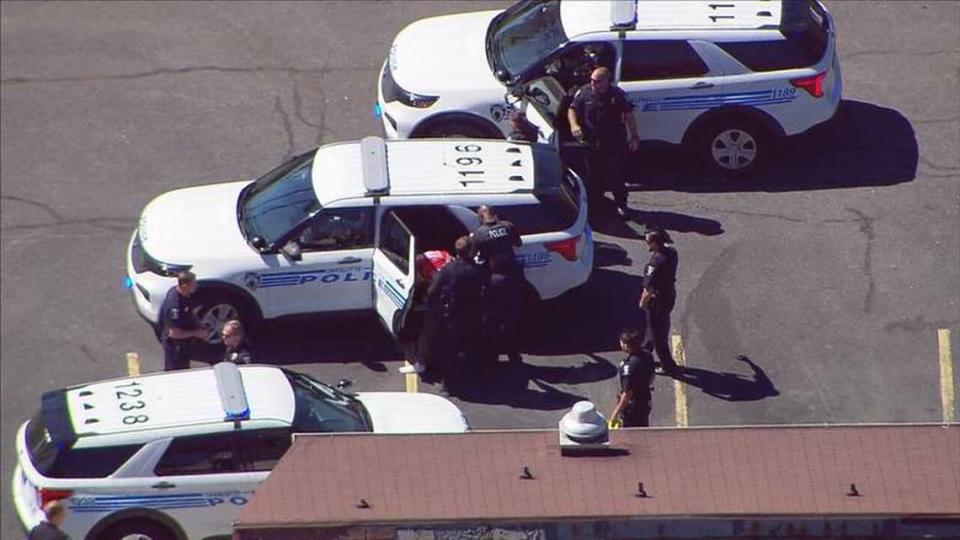 In this image taken from WSOC’s helicopter, Charlotte-Mecklenburg police appear to hold someone in custody after a fatal shooting in the 6400 block of Albemarle Road on Friday, September 23, 2022.