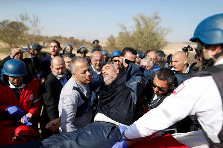 Arab Israeli lawmaker from the Joint Arab List, Osama Saadi (C), is evacuated by medics during clashes between Arab Israelis and Israeli riot policemen in Umm Al-Hiran, a Bedouin village in Israel's southern Negev Desert January 18, 2017. REUTERS/Ammar Awad