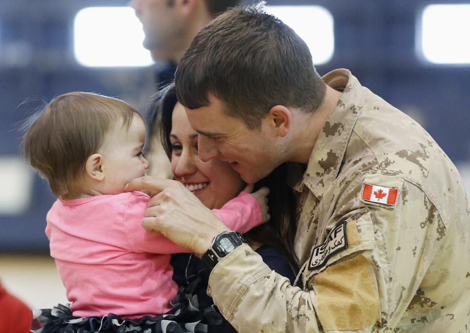 Leading Seaman Brett Price is reunited with his wife Brittany and daughter Brynlee after arriving from Afghanistan, in Ottawa