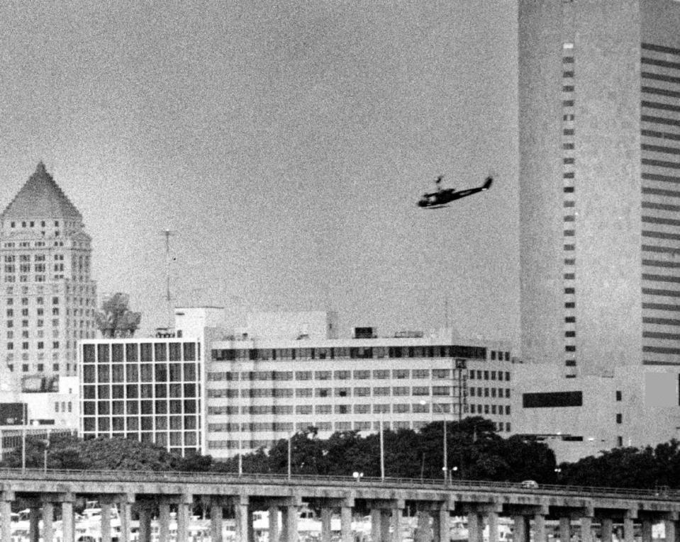 A helicopter sprays for mosquitoes over downtown Miami in 1984.