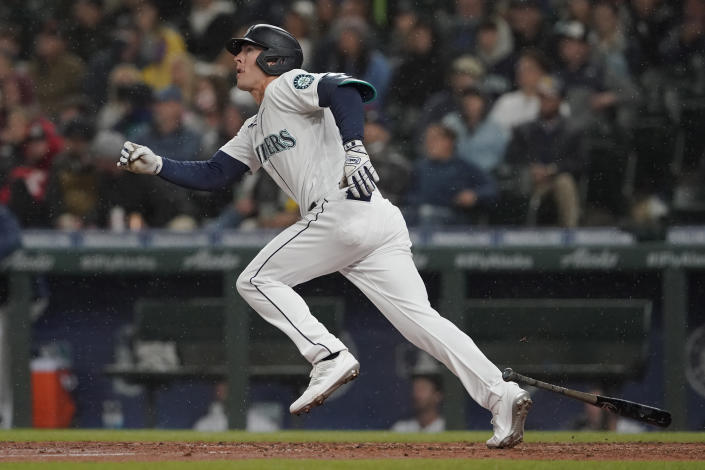 Seattle Mariners' Dylan Moore watches his two-run home run as rain falls in the sixth inning of a baseball game against the Houston Astros, Monday, Aug. 30, 2021, in Seattle. (AP Photo/Ted S. Warren)