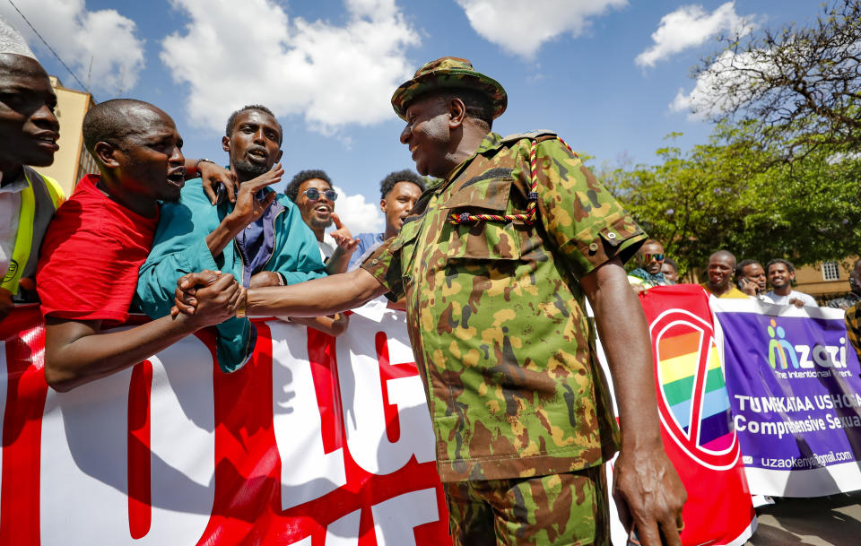 Kenyan police shake hands with members of Kenya Muslim community during a protest against a ruling by the Kenya supreme court for upholding the National Gay and Lesbian Human Rights Commission (NGLHRC) to register the association in Nairobi, Friday Oct. 6 2023. The protests took place after the Friday prayers with demonstrator’s calling out Kenya’s highest court for “condoning immorality.” (AP Photo/Brian Inganga)