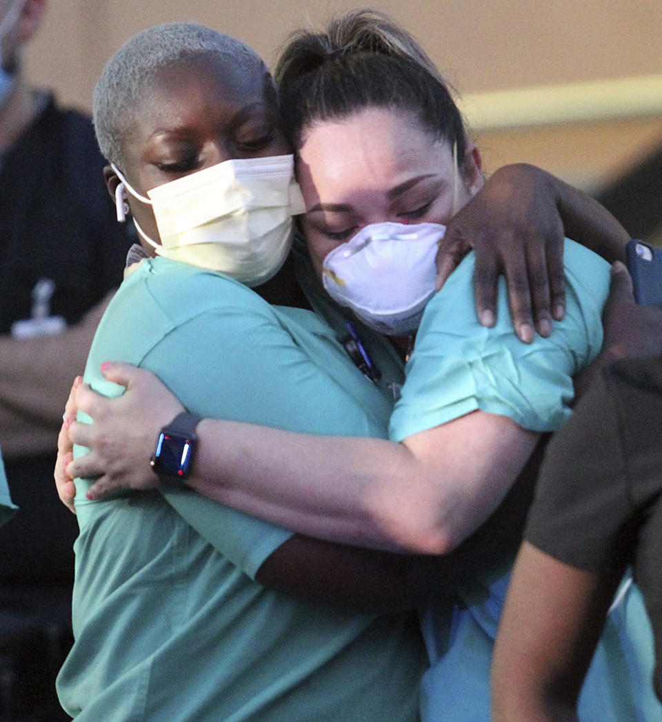 Addie Adebiyi, a registered nurse from Maryland hugs Rosa Aguirre at DHR, Friday, Sept. 4, 2020, in Edinburg, Texas. (Delcia Lopez/The Monitor via AP)