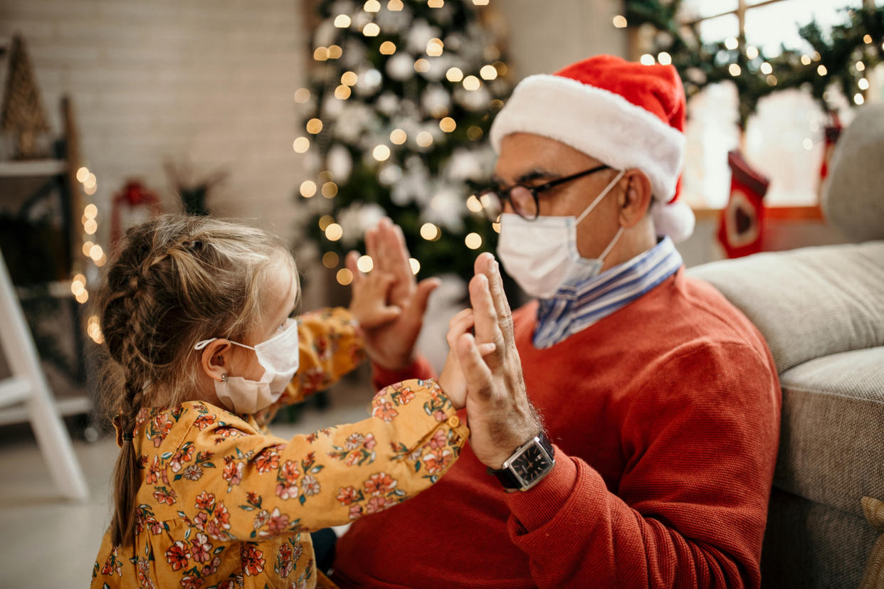 Senior men and his granddaughter spending time together in home for Christmas