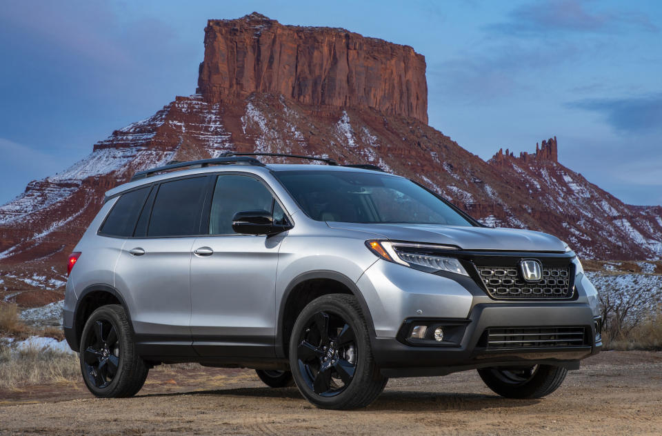 A silver 2019 Honda Passport, a midsize crossover SUV.