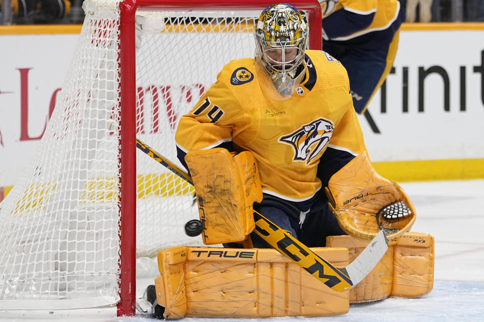 Nashville Predators goaltender Juuse Saros (74) lets a goal by Calgary Flames defenseman Noah Hanifin get past during the first period of an NHL hockey game Wednesday, Nov. 22, 2023, in Nashville, Tenn. (AP Photo/George Walker IV)