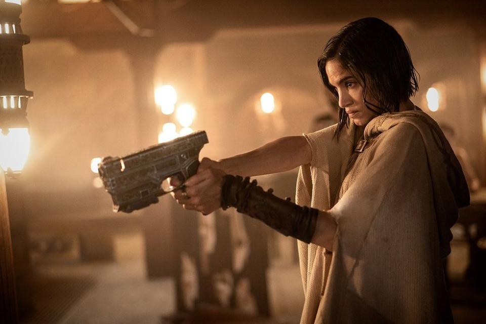 Sofia Boutella holds a pistol