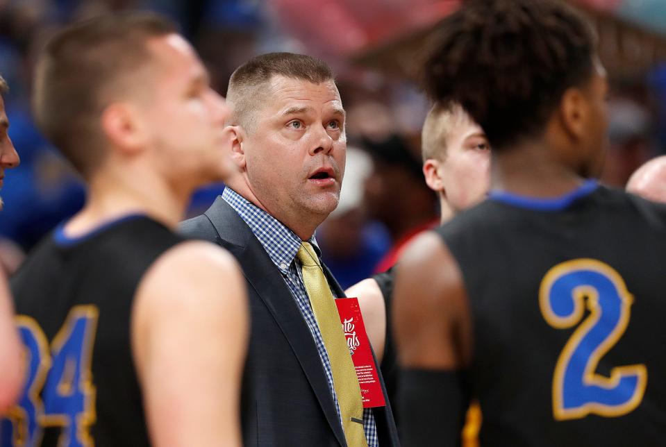 Fort Wayne Blackhawk Christian Braves head coach Marc Davidson talks to his players during a timeout in the first half of the IHSAA A Boys Basketball State Finals at Bankers Life Fieldhouse on Mar. 23, 2019.