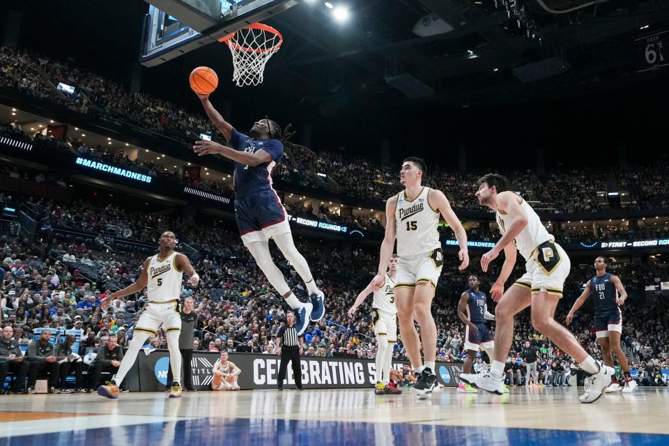 Fairleigh Dickinson guard Heru Bligen makes a layup in front of Purdue center Zach Edey (15) during the first round of the NCAA men’s basketball tournament last season at Nationwide Arena.