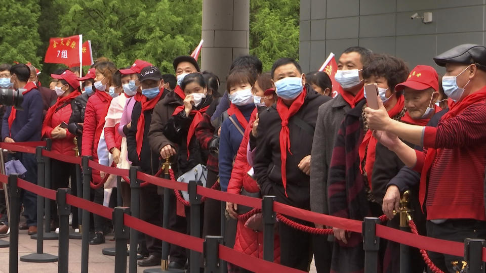 Tourist groups stand in line to enter the Jinggangshan Revolution Museum in Jinggangshan in southeastern China's Jiangxi province, on April 8, 2021. On the hundredth anniversary of the Chinese Communist Party, tourists in China are flocking to historic sites and making pilgrimages to party landmarks. (AP Photo/Emily Wang)