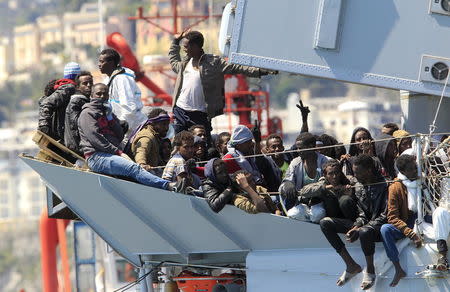 Migrants stand on board of Italian Navy ship Chimera before to be disembarked in the southern harbor of Salerno. REUTERS/Ciro De Luca