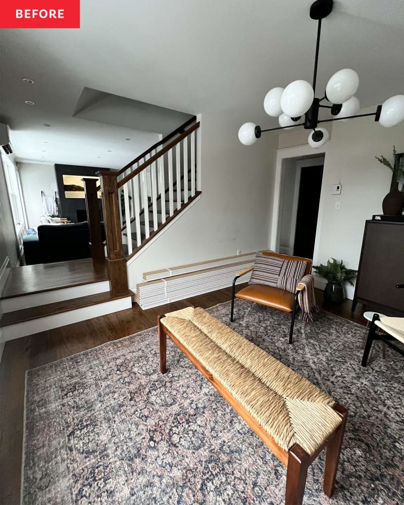 A living room with two chairs, a bench, and a staircase.