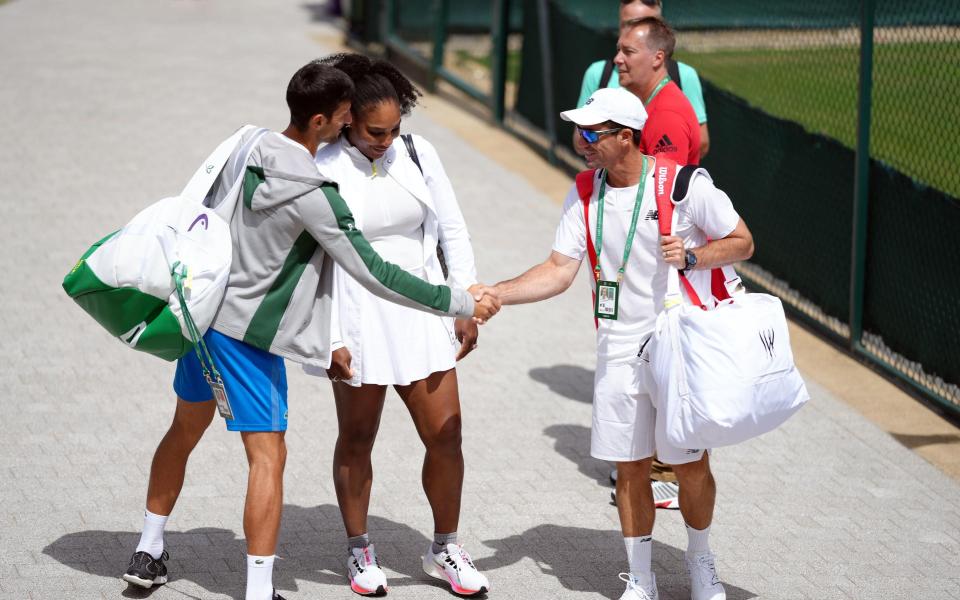 Novak Djokovic shakes the hand of Serena Williams' (centre) coach Eric Hechtman (right) on day two of the 2022 Wimbledon Championships at the All England Lawn Tennis and Croquet Club, Wimbledon.  - PA