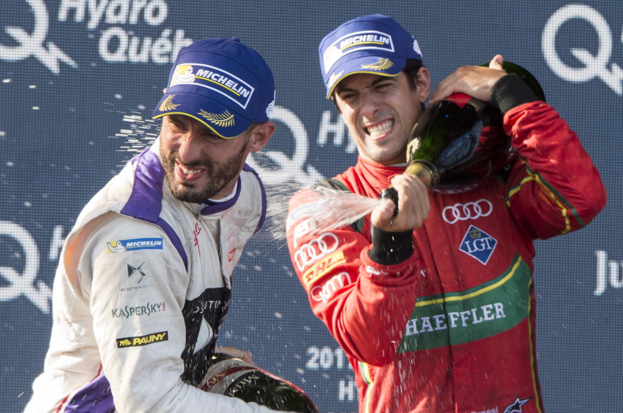 Drivers champion Lucas Di Grassi of Brazil, ABT Schaeffler FE02 (11) sprays race third place finisher Jose Maria Lopez of Argentina, DS Virgin DVS-02 (37) during victory ceremonies at the Montreal Formula ePrix electric car race, Sunday, July 30, 2017 in Montreal. (Paul Chiasson/The Canadian Press via AP)