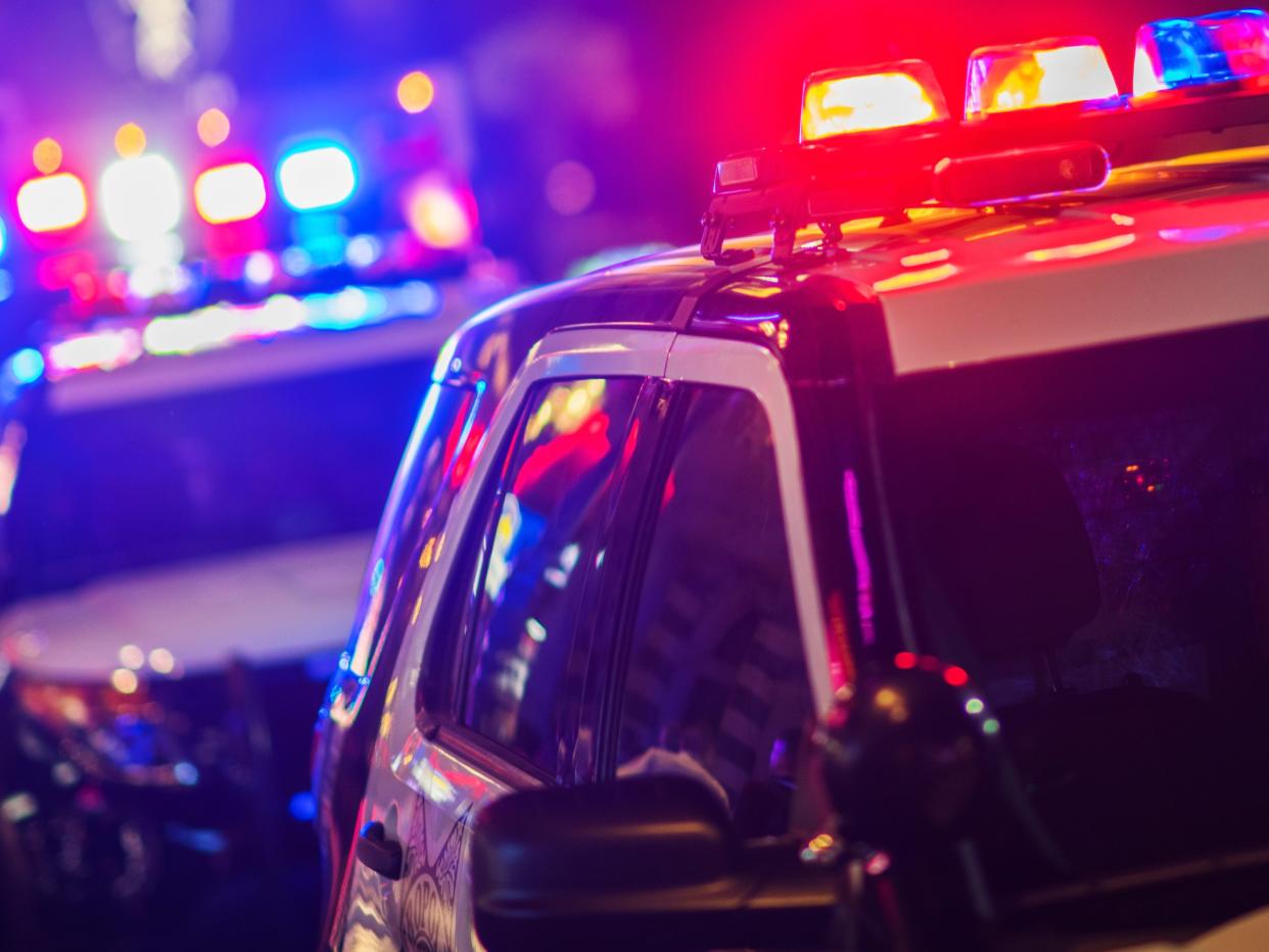 A stock photo of police vehicles with flashing lights.