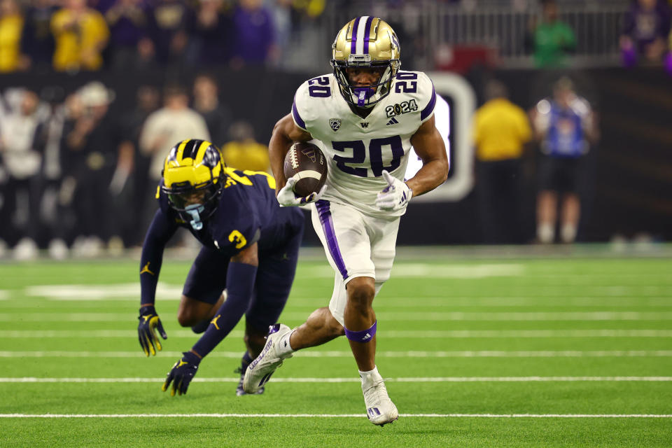 HOUSTON, TEXAS - JANUARY 8: Tybo Rogers #20 of the Washington Huskies rushes against the Michigan Wolverines during the 2024 CFP National Championship game at NRG Stadium on January 8, 2024 in Houston, Texas. (Photo by Jamie Schwaberow/Getty Images)