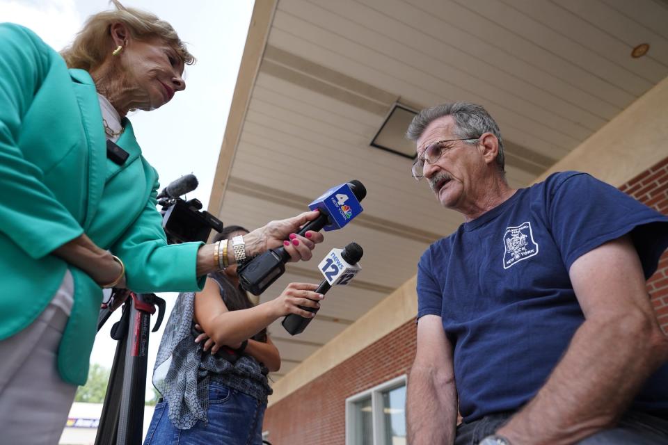 Spring Valley firefighter George Cich is interiew by the local press after Spring Valley Mayor Alan Simon's press conference at the village hall on Thursday, July 20, 2023.