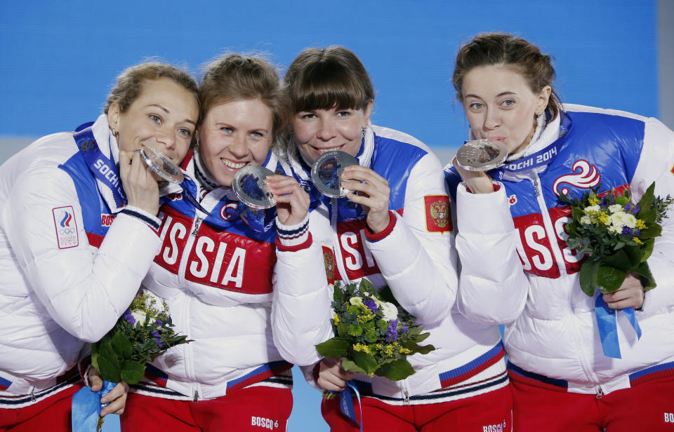 Silver medalists Olga Zaitseva, far left, Yana Romanova, Ekaterina Shumilova and Olga Vilukhina of Russia pose during the ceremony at the 2014 Winter Olympics in Sochi.&nbsp; (Photo: Eric Gaillard / Reuters)