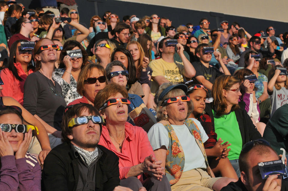 Observers at the University of Colorado's Folsom Field football stadium use solar eclipse glasses to view the annular solar eclipse of May 20, 2012. <cite>Casey A. Cass/University of Colorado</cite>