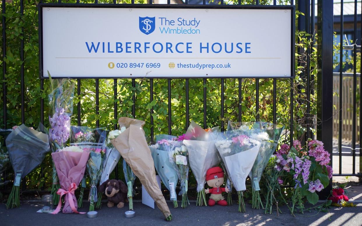 Flowers and toys placed outside the school after a Land Rover crashed into the building on the last day of term