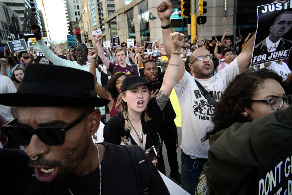 About 300 protesters march through downtown Minneapolis on Tuesday, July 31, 2018, to protest the killing of Thurman Blevins by Minneapolis police officers. Activists and family members of the black man marched through downtown Tuesday, blocking trains and intersections during the evening rush hour as they chanted some of Thurman Blevins' last words: "Please don't shoot me! Leave me alone!" (Richard Tsong-Taatarii/Star Tribune via AP)