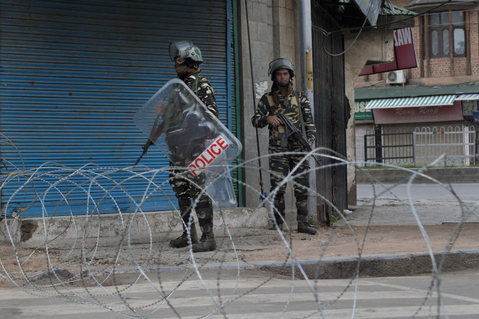 In this Tuesday, Aug. 6, 2019 photo, Indian paramilitary soldiers stand guard during curfew in Srinagar, Indian controlled Kashmir. The lives of millions in India's only Muslim-majority region have been upended since the latest — and most serious — crackdown followed a decision by New Delhi to revoke the special status of Jammu and Kashmir and downgrade the Himalayan region from statehood to a territory. Kashmir is claimed in full by both India and Pakistan, and rebels have been fighting Indian rule in the portion it administers for decades. (AP Photo/Dar Yasin)