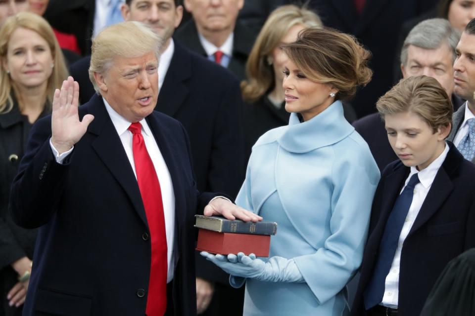 President Donald Trump takes the oath of office as his wife Melania Trump holds the bible and his son Barron Trump looks on, on the West Front of the U.S. Capitol on January 20, 2017 in Washington, DC (Getty Images)