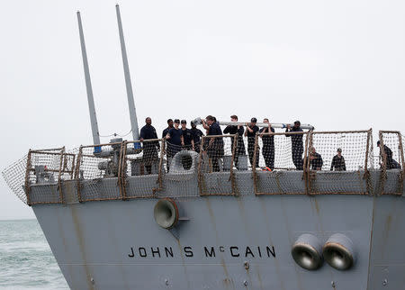 Personnel work on the U.S. Navy guided-missile destroyer USS John S. McCain after a collision, in Singapore waters August 21, 2017. REUTERS/Ahmad Masood