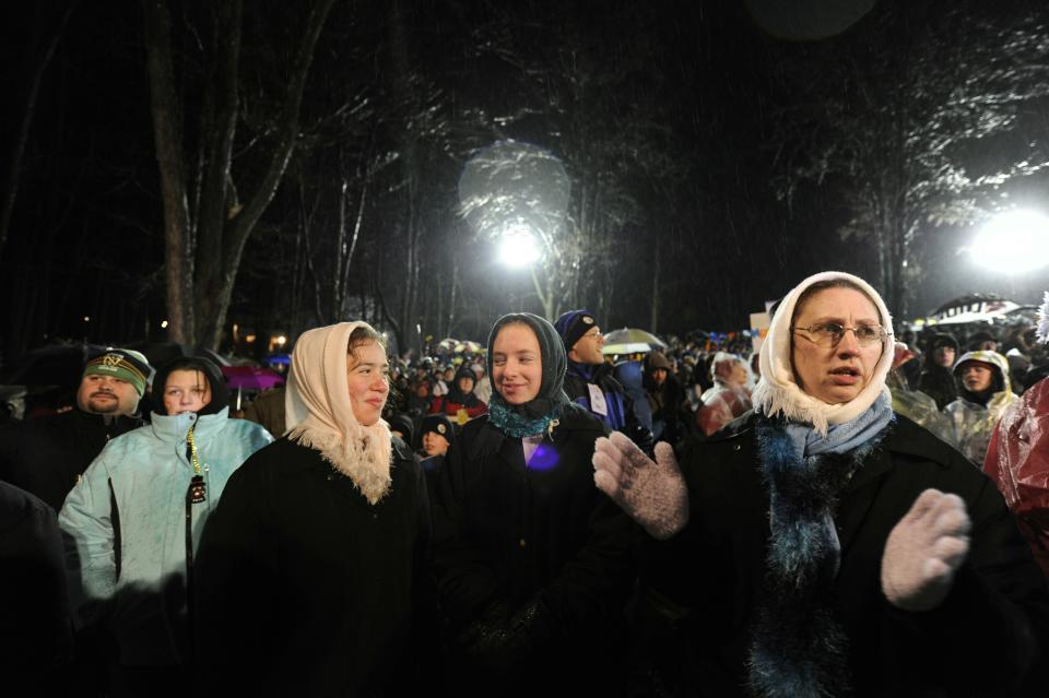 PUNXSUTAWNEY, PA - FEBRUARY 2: A crowd gathers to watch Punxsutawney Phil come out of his burrow during the 125th annual Groundhog Day festivities on February 2, 2011 in Punxsutawney, Pennsylvania. Phil came out and did not see his shadow predicting an early spring. Groundhog Day is a popular tradition in the United States and Canada. A smaller than usual crowd this year of less than 15,000 people spent a night of revelry awaiting the sunrise and the groundhog's exit from his winter den. If Punxsutawney Phil sees his shadow he regards it as an omen of six more weeks of bad weather and returns to his den. Early spring arrives if he does not see his shadow causing Phil to remain above ground. (Photo by Jeff Swensen/Getty Images)