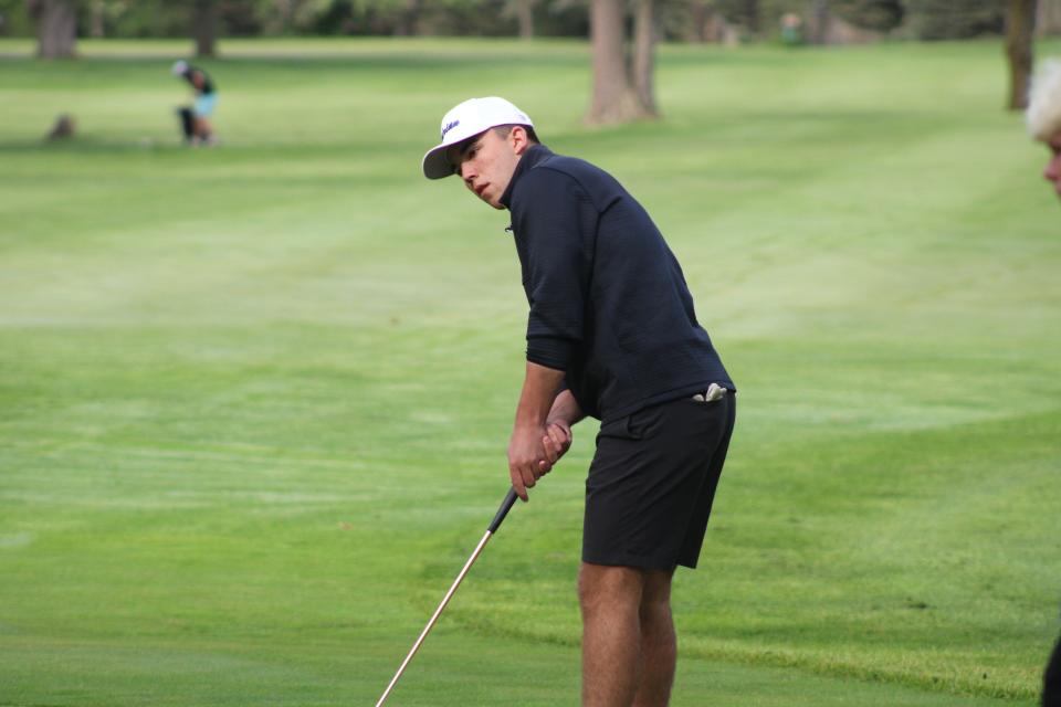 Adrian's Carson Ritz putts during Monday's Lenawee County Boys Golf Invite at The Hills of Lenawee in Adrian.