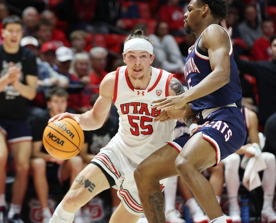 Utah Utes guard Gabe Madsen (55) drives on Arizona Wildcats guard KJ Lewis (5) in Salt Lake City on Thursday, Feb. 8, 2024. | Jeffrey D. Allred, Deseret News