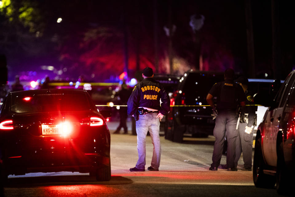 Houston Police Department officers stand by the scene of a shooting in Houston on Saturday, Dec. 7, 2019. A Houston police officer was shot Saturday evening and a suspect was being sought, authorities said. (Marie D. De Jesus/Houston Chronicle via AP)