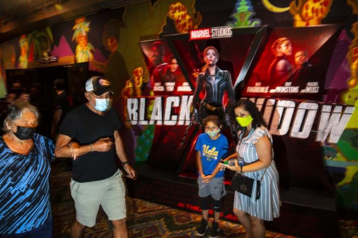 Hollywood, CA - July 09: Masked patrons walk past a lobby display for Marvel Studios&#39; &quot;Black Widow,&quot; on opening weekend at the El Capitan Theatre, in the heart of Hollywood, CA, Friday, July 9, 2021. (Jay L. Clendenin / Los Angeles Times)