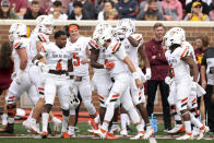 Bowling Green quarterback Matt McDonald (3) celebrates with teammates on the sideline after scoring a touchdown against Minnesota during the first half of an NCAA college football game Saturday, Sept. 25, 2021, in Minneapolis. (AP Photo/Stacy Bengs)