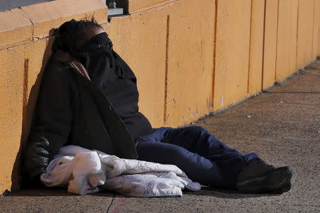 A homeless man rests on the street in New York January 4, 2016. REUTERS/Lucas Jackson