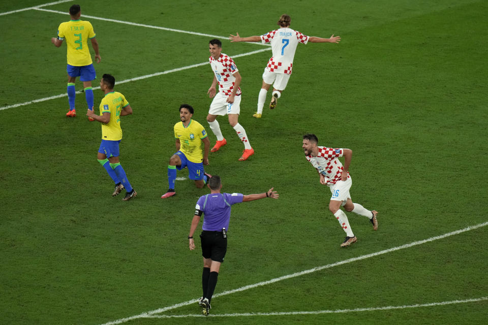 Croatia's Bruno Petkovic, right, celebrates after scoring his side's first goal during the World Cup quarterfinal soccer match between Croatia and Brazil, at the Education City Stadium in Al Rayyan, Qatar, Friday, Dec. 9, 2022. (AP Photo/Alessandra Tarantino)