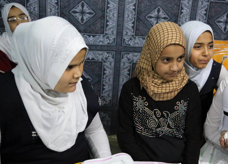 In this Thursday, March 13, 2014 photo, girls study at an orphanage in Baghdad, Iraq, Thursday, March 13, 2013. The director of the shelter says that she will not allow marriage of minors at her orphanage, despite a contentious civil status draft law for Iraqi Shiite community that allows child marriage and restricts women’s rights that has stirred up a row among many Iraqis who see it as a setback for child and women rights, threatening to add more divisions and woos to the society that is already in fragments. (AP Photo/Karim Kadim)