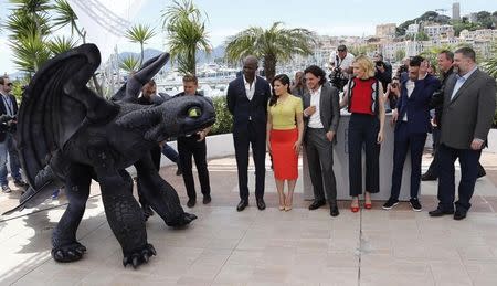 Director Dean DeBlois (R), cast members (L-2ndR) Djimon Hounsou who voices Drago Bludvist character, America Ferrera who voices Astrid character, Kit Harington who voices Eret character, Cate Blanchett who voices Valka character, and Jay Baruchel who voices Hiccup character, pose with a figure of Toothless the Dragon character during a photocall for the film "How to Train Your Dragon 2" out of competition at the 67th Cannes Film Festival in Cannes May 16, 2014. REUTERS/Regis Duvignau