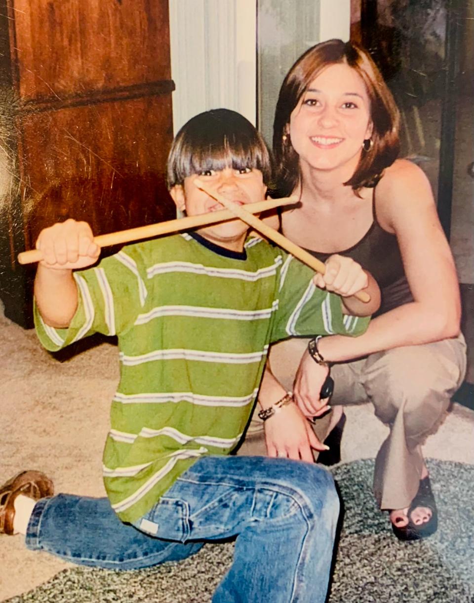 Ramon Cisneros holds up drumsticks as a youngster. At 4 years old, he would play songs on his toy piano. When he heard Beethoven for the first time, his love for music solidified.