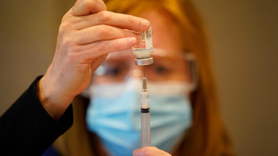 Penny Cracas of the Chester County Health Department fills a syringe with the Moderna COVID-19 vaccine on Tuesday in West Chester, Pa.