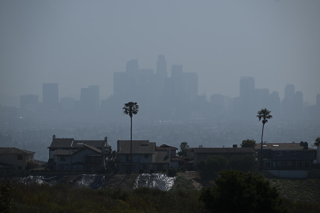 The skyline of downtown Los Angeles obscured by hazy skies following a wildfire north of the city on a moderate air quality day on June 20. (Patrick T. Fallon/AFP via Getty Images)