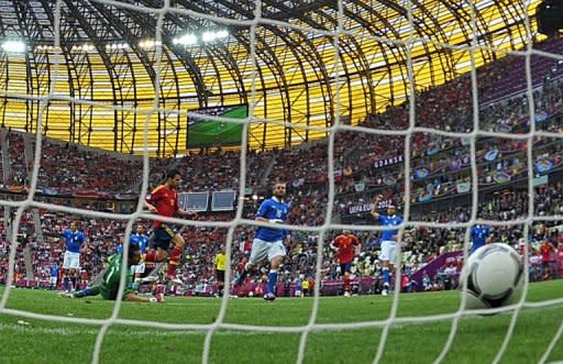 Spanish forward Cesc Fabregas (2nd L) reacts after scoring past Italian goalkeeper Gianluigi Buffon (L) during the Euro 2012 championships football match Spain vs Italy at the Gdansk Arena. The match ended in a 1-1 draw