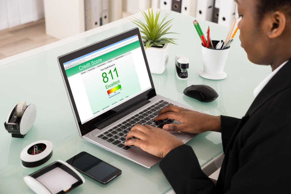 Man Using Laptop To View His Excellent Credit Score Of 811