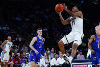 Michigan State's A.J. Hoggard (11) drives past Kansas' Christian Braun (2) during the first half of an NCAA basketball game Tuesday, Nov. 9, 2021, in New York. (AP Photo/Frank Franklin II)