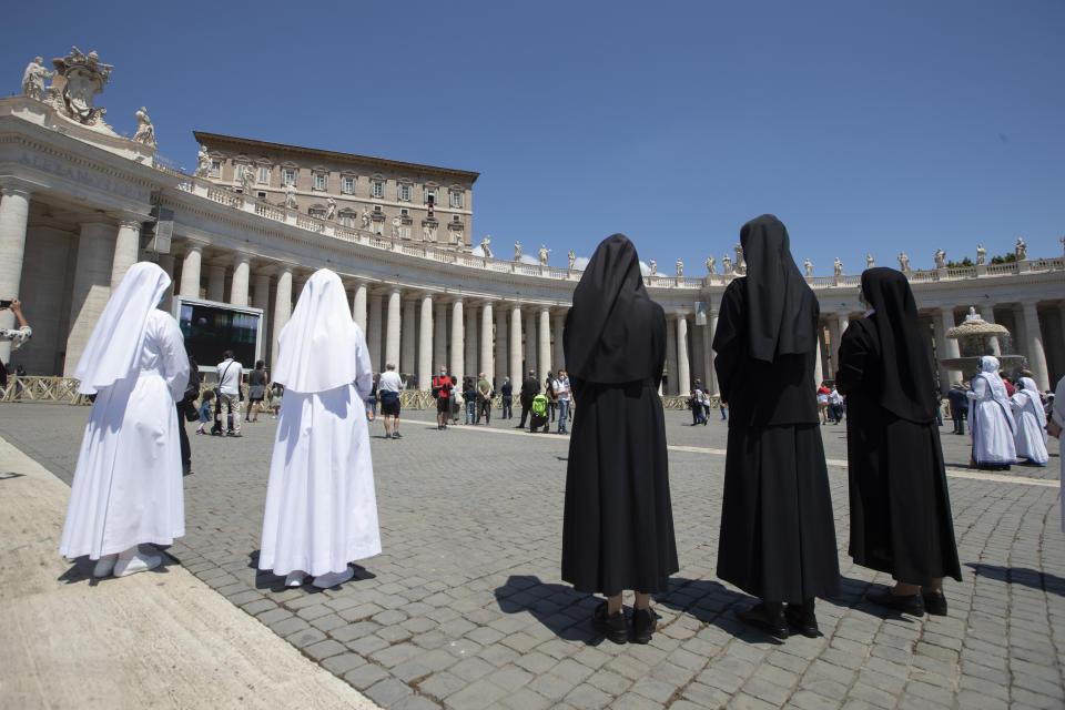 Nuns listen to Pope Francisin St. Peter's Square at the Vatican, Sunday, May 31, 2020. Pope Francis has cheerfully greeted people in St. Peter’s Square on Sunday, as he resumed his practice of speaking to the faithful there for the first time since lockdown began in Italy and at the Vatican in early March. Instead of the tens of thousands of people who might have turned out on a similarly brilliantly sunny day like this Sunday, in pre-pandemic times, perhaps a few hundred came to the square, standing well apart from others or in small family groups. (AP Photo/Alessandra Tarantino)